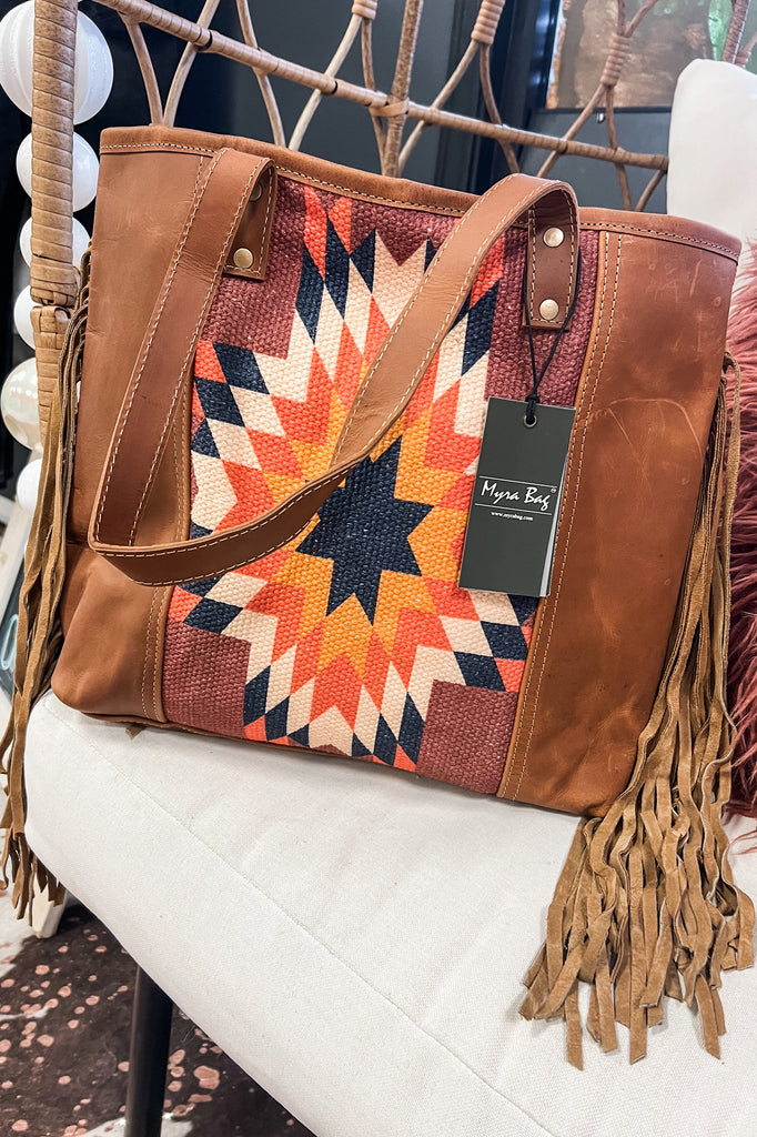 a backpack or a worn-in leather bag perhaps with fringe The Scottsdale Aztec Fringe Backpack – Southern Roots Boutique